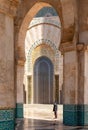 local tour guide waiting on his guests under the arched portals and gates of the Hassan II Mosque in Casablanca Royalty Free Stock Photo