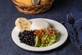 Casado, typical Costa Rican dish with rice, beans and vegetables in white plate