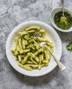 Casarecce pasta with cilantro pesto sauce on a grey background, top view. Delicious vegetarian lunch Royalty Free Stock Photo