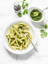 Casarecce pasta with cilantro pesto sauce on a light background, top view. Delicious vegetarian lunch Royalty Free Stock Photo