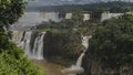 A cascade of Iguazu waterfalls collapsing from the edge of the plateau