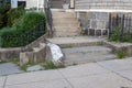 Cascade of residential concrete stairs to a sidewalk