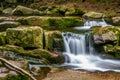 Cascade on a spring in Tatra mountains with rocks covered in moss. Smooth water fall Royalty Free Stock Photo