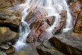 Cascade water streams splash and crash through the rocks long exposure photograph. Andahalena Ella waterfall in Beraliya rain Royalty Free Stock Photo