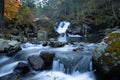 Cascade of waterfalls in the autumn forest.