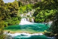 Cascade waterfalls in the forest flows into the turquoise lake. Krka, National Park, Dalmatia, Croatia