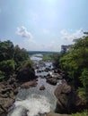 The Cascading Beauty of a Rocky River Embellished with Lush Trees