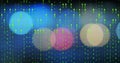 Cascading columns of green binary digits streaming over blurred bokeh circles, digital data theme Royalty Free Stock Photo