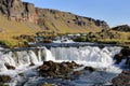 Cascading stream of pristine water flows around large rocks in a peaceful natural setting Royalty Free Stock Photo