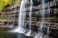 cascading water over layered rock wall