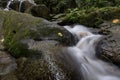 Cascading water stream at Kanching waterfall, located in Malaysia,wet and mossy rock, surrounded by green rain forest