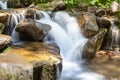 Cascading waterfall closeup very smooth water with wet rocks Royalty Free Stock Photo