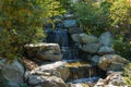 Cascading waterfall in Japanese garden of public landscape park of Krasnodar or Galitsky park Royalty Free Stock Photo