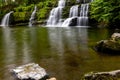 Cascading waterfall in a lush green forest (Sgwd y Pannwr, Wales