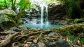 Cascading waterfall in rainforest falls into blue pool - nature and great outdoors image Royalty Free Stock Photo