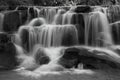 Cascading waterfall in rainy season deep inside the tropical forest of Thailand in black and white color Royalty Free Stock Photo