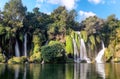 Nature\'s Symphony: A Tranquil Waterfall Setting with Cascading Waters and Lush Surroundings