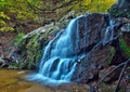 Cascading woodland waterfall and fall foliage Royalty Free Stock Photo