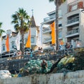 Fishermen working on rusty fishing traps, made of iron bars and green nylon nets, piled up on a dock a pier in Cascais, Portugal Royalty Free Stock Photo