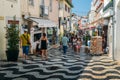 Pedestrians on busy commercial Rua Frederico Arouca in the historic centre of Cascais, Portugal during a summer day