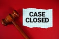 Case Closed text written on rip paper with wooden judgment gavel on red background Royalty Free Stock Photo