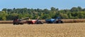 Case 8120 combine unloading corn into a Killbros grain wagon being pulled by a Case 305 tractor while a Case 400 tractor pulling a