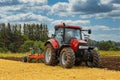 Case IH Tractor and Plow Working on Field