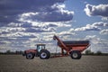 Case IH tractor and an Unverferth grain cart rest in a completely harvested field Royalty Free Stock Photo