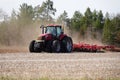 New Lisbon, Wisconsin USA - May 4th, 2022: Farmer driving a Case 305 Magnum tractor while pulling a plow to plow up a farming fiel