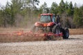 New Lisbon, Wisconsin USA - May 4th, 2022: Farmer driving a Case 305 Magnum tractor while pulling a plow to plow up a farming fiel