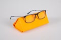 Case with new optic modern medic glasses orange design box for eyeglasses isolated on grey background