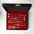 Case of Set of Tuning Forks for hearing tests on white background . Medical equipment. Medical and Healthcare concept