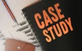 Case studies text written on a diary cover orange on black. Business concept. Selective focus Royalty Free Stock Photo