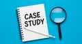 Case Study Concept: Notebook, Pencil, and Magnifying Glass on Blue Background Royalty Free Stock Photo
