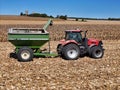 Case 220 tractor pulling a Brent 674 grain cart with farm scene in the background Royalty Free Stock Photo