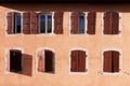 Casement windows with brown wooden shutters