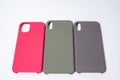 Cases for smartphones in different colors on a white background.