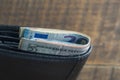 Cash American dollars and euro banknotes in a black leather wallet. Paper money closeup. The concept of payment and savings Royalty Free Stock Photo