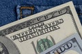 cash American hundred dollar bills lying in the pocket of jeans Royalty Free Stock Photo