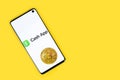 Cash app icon on phone with Bitcoin on yellow background