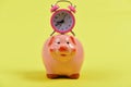 Cash box with financial income. Piggy bank with alarm clock. Royalty Free Stock Photo