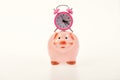 Cash box with financial income. Piggy bank with alarm clock. Royalty Free Stock Photo