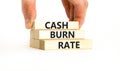 Cash burn rate symbol. Concept words Cash burn rate on wooden blocks on a beautiful white table white background. Businessman hand Royalty Free Stock Photo