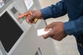 Close up picture of a man retrieving money from ATM