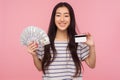 Cash deposits. Portrait of satisfied bank customer, happy brunette girl holding dollars banknotes, credit card Royalty Free Stock Photo
