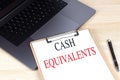 CASH EQUIVALENTS text on clipboard on laptop