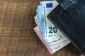Cash euro banknotes in a black leather wallet. Paper money closeup. The concept of payment and savings Royalty Free Stock Photo