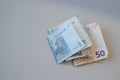 Cash or Euro paper money notes on light gray background