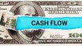 Cash Flow Finance. The word Cash Flow in the background of the US dollar. Money Flowing through a Business Pipeline Royalty Free Stock Photo