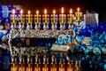 Cash gift with burning menorah with reflection for Hanukkah